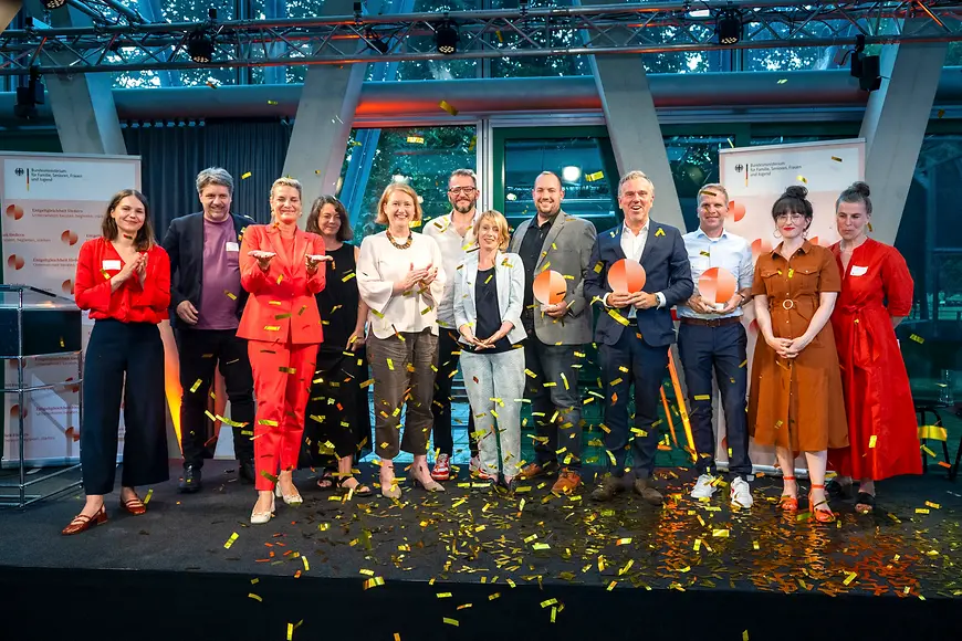 Teilnehmende gemeinsam auf der Bühne mit Lisa Paus