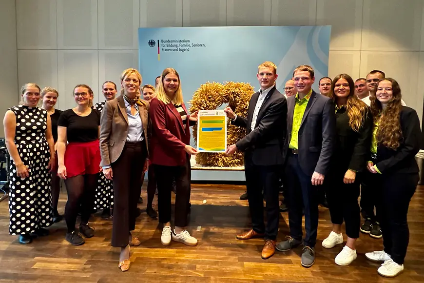 Gruppenfoto mit Karin Prien, der Erntekrone und Jugendlichen