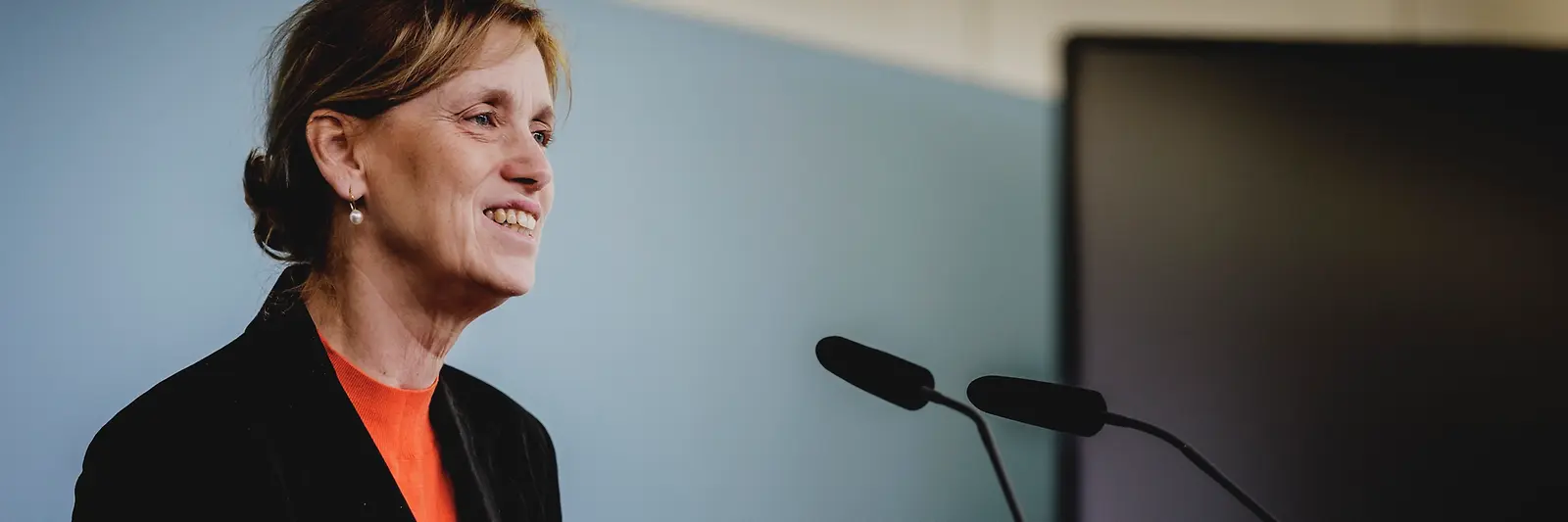 Karin Prien an einem Rednerpult vor Menschen