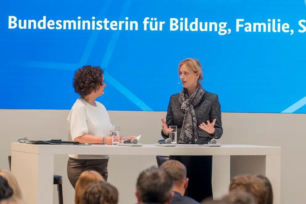 Karin Prien an einem Rednerpult vor Menschen